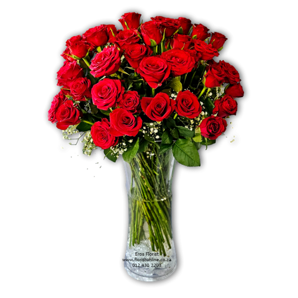 red roses in clear glass vase